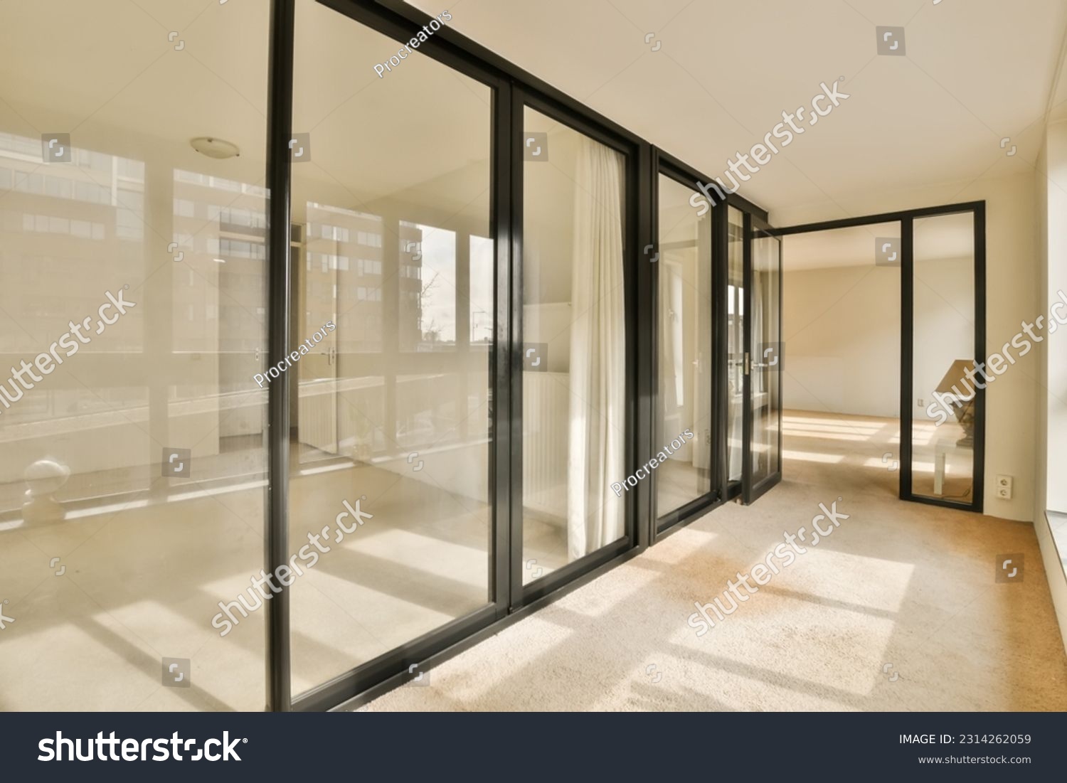 an empty room with sliding glass doors and floor to ceiling windows in a new apartment building, london, uk stock photo #2314262059