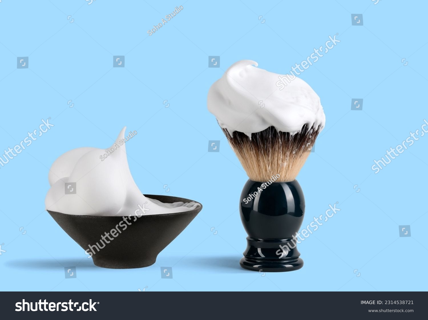 Shaving brush with raccoon fur and shaving foam in ceramic bowl on blue background. #2314538721