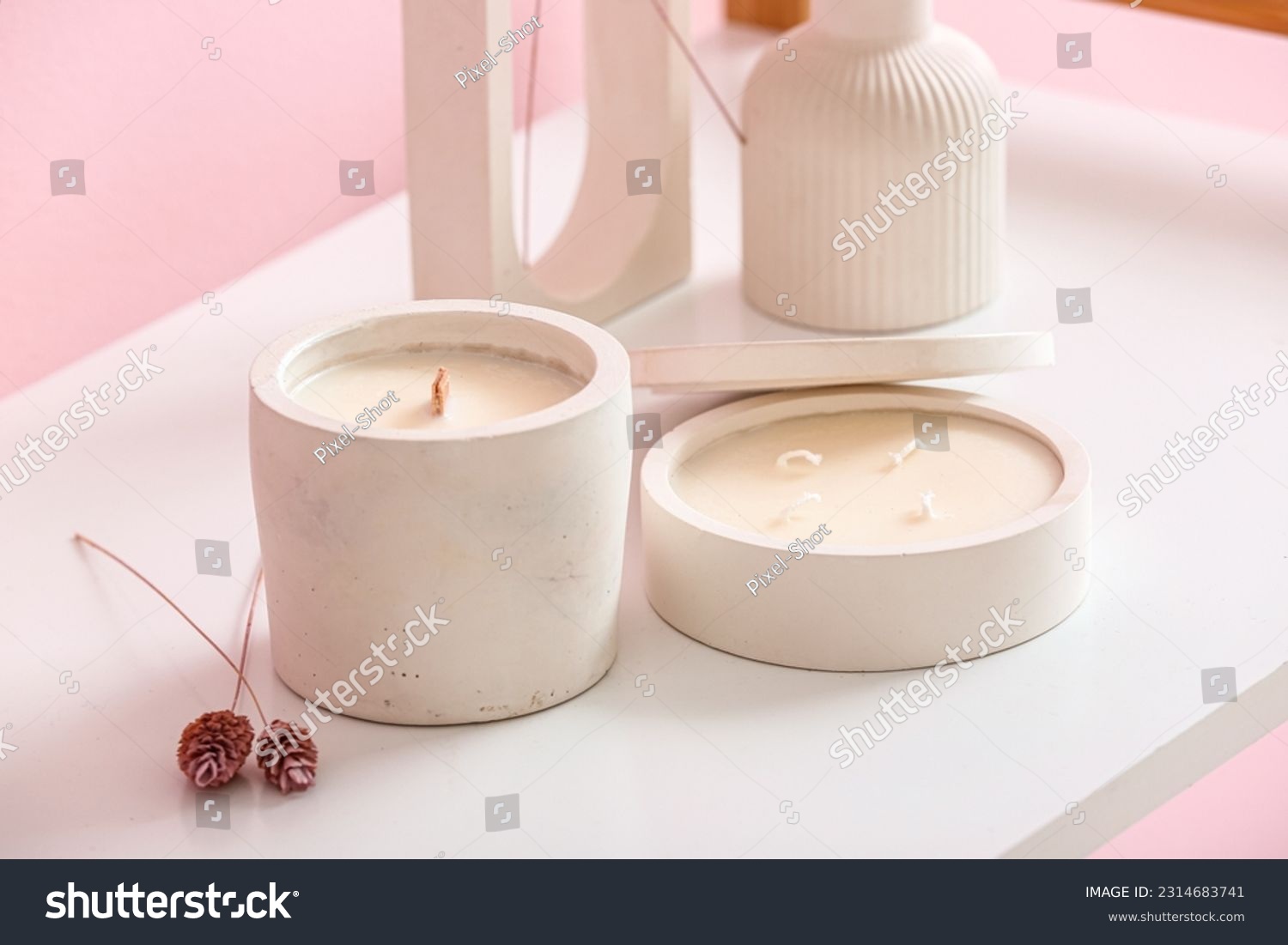 Holders with candles and decor on table in room, closeup #2314683741