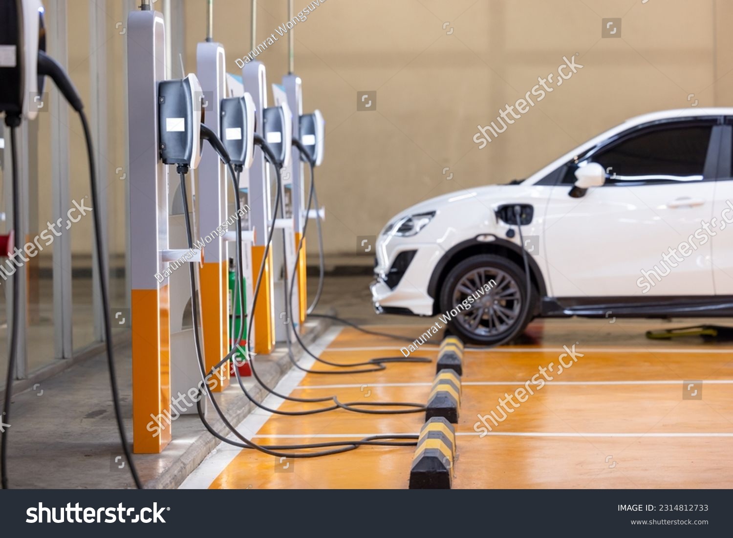 EV charging an electric car. Power supply for electric car charging. Socket for electrical car battery charger. EV car charging station in parking. Nature energy, Clean energy, Green eco concept. #2314812733