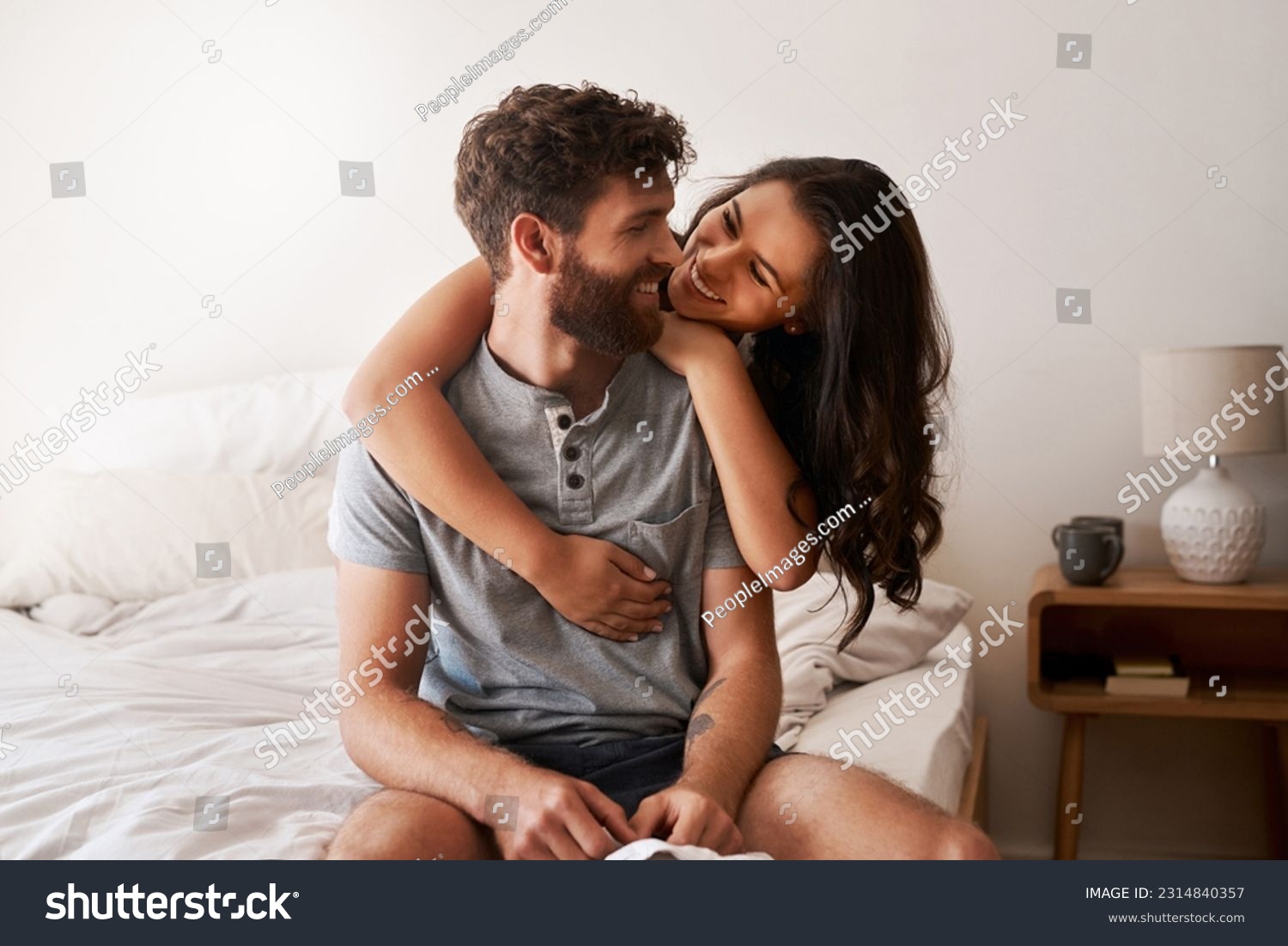 Love, home bedroom and happy couple hug, bond and spending relax morning together, bonding and smile. Happiness, marriage or romantic people hugging with affection, care and enjoy quality time on bed #2314840357