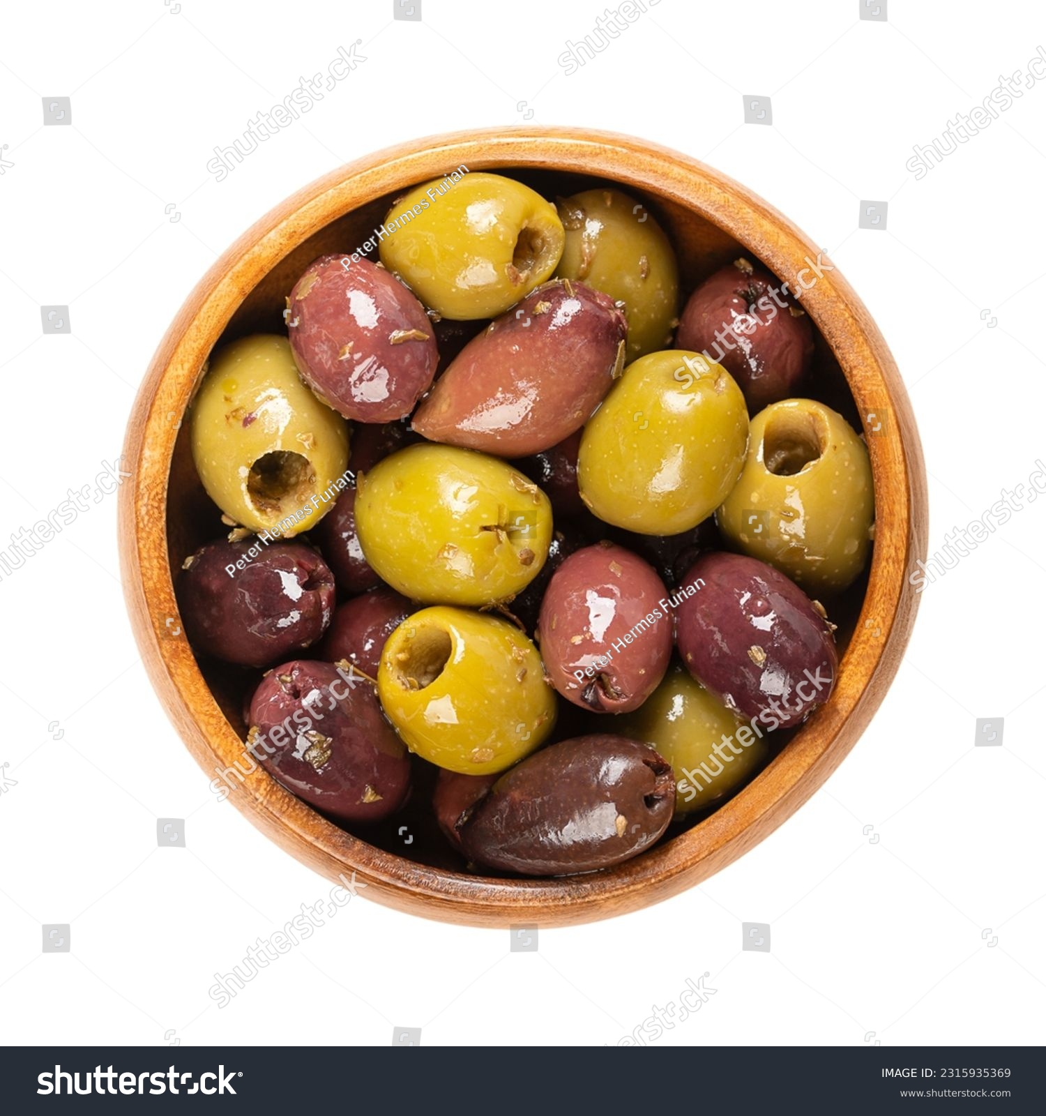Pitted Kalamata and green olives, in a wooden bowl. Mix of organic Greek olives, green and black, with herbs, preserved in native olive oil. Popular table olives, used as snack, appetizer or garnish. #2315935369