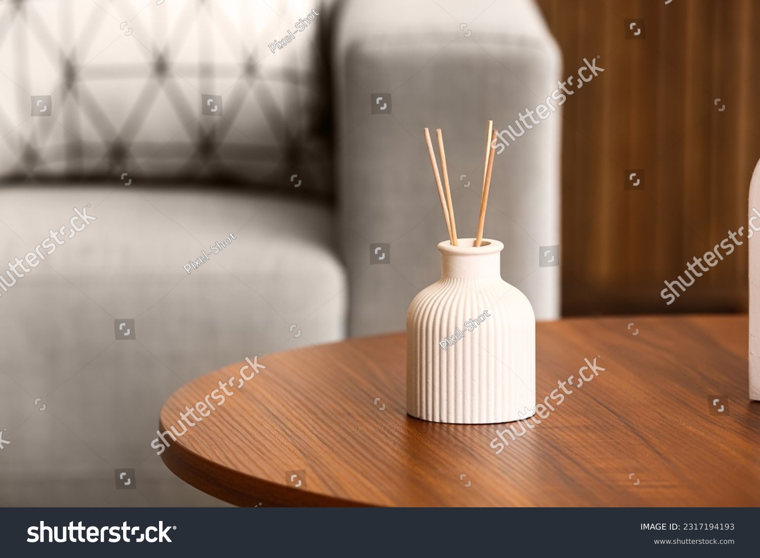 Bottle of reed diffuser on table in room, closeup #2317194193