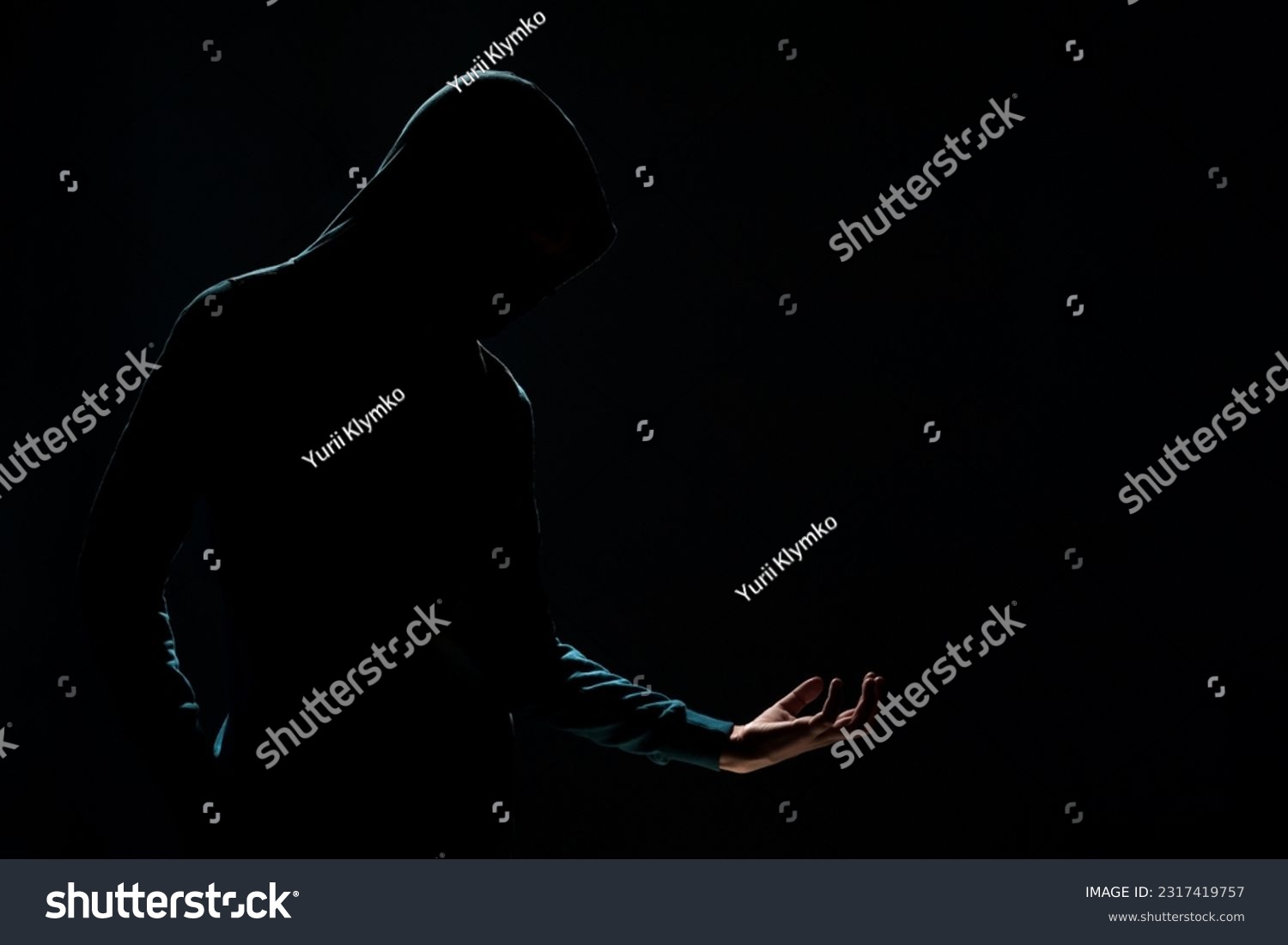 The silhouette of unknown person with backlight on the dark background #2317419757