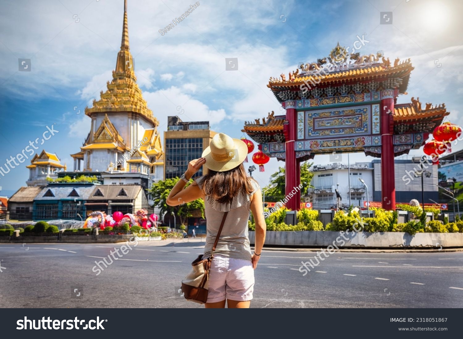 A tourist woman on sightseeing tour stands in front of the Chinatown Gate at the famous Yaowarat Road, Bangkok, Thailand #2318051867
