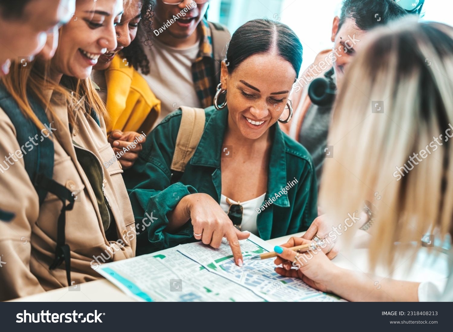 Group of young people doing check-in of youth hostel guest house - Happy tourists talking with receptionist at hotel lobby - Summer vacations and tourism concept #2318408213