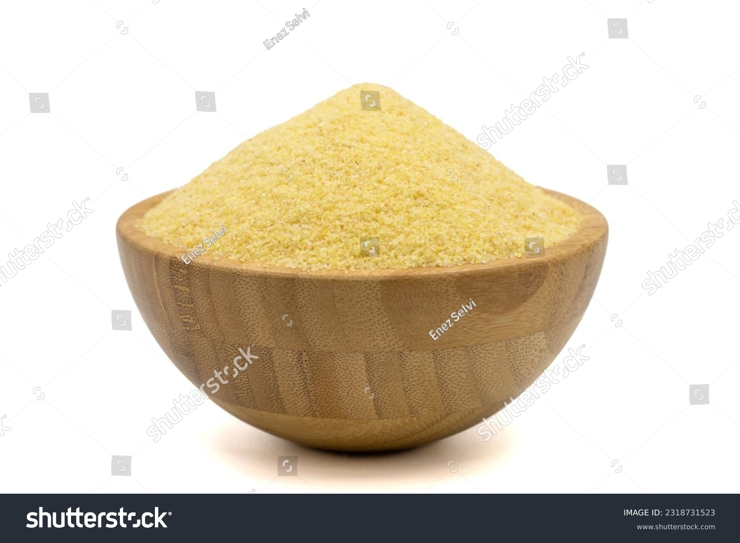 Dry organic semolina flour isolated on white background. Uncooked organic semolina in wooden bowl #2318731523