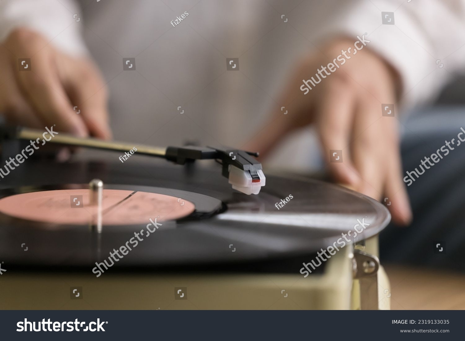 Close up view unknown female using old-fashioned equipment to listening favourite music on vinyl record old turntable player. Classical melody for retro style sound lovers, leisure, nostalgic mood #2319133035