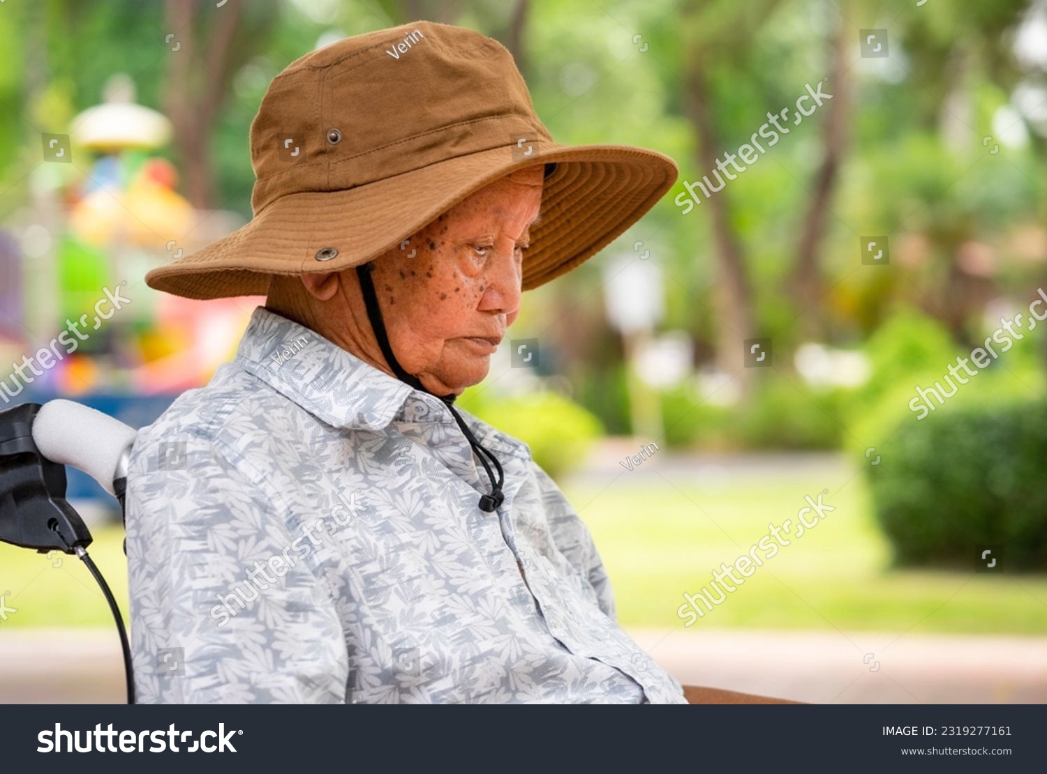 closed up old Asian grandpa sitting alone in the park #2319277161