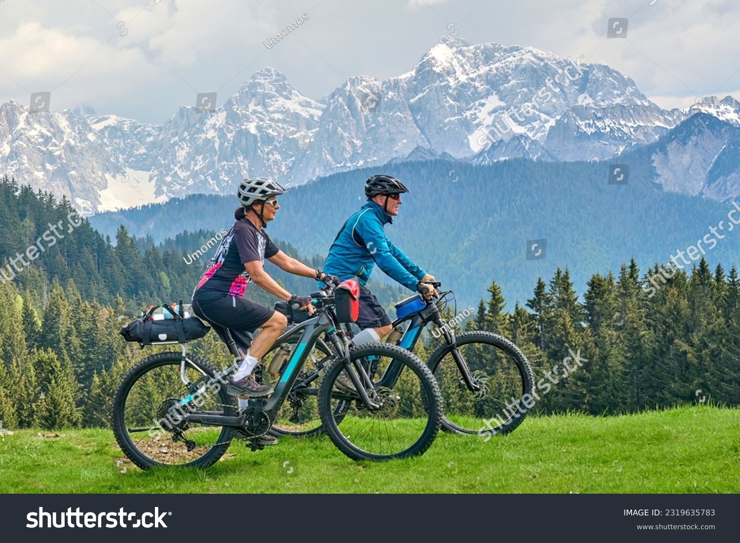active senior couple on a mountain bike tour in the Julian Alps above Kranska Gora in Slovenia #2319635783