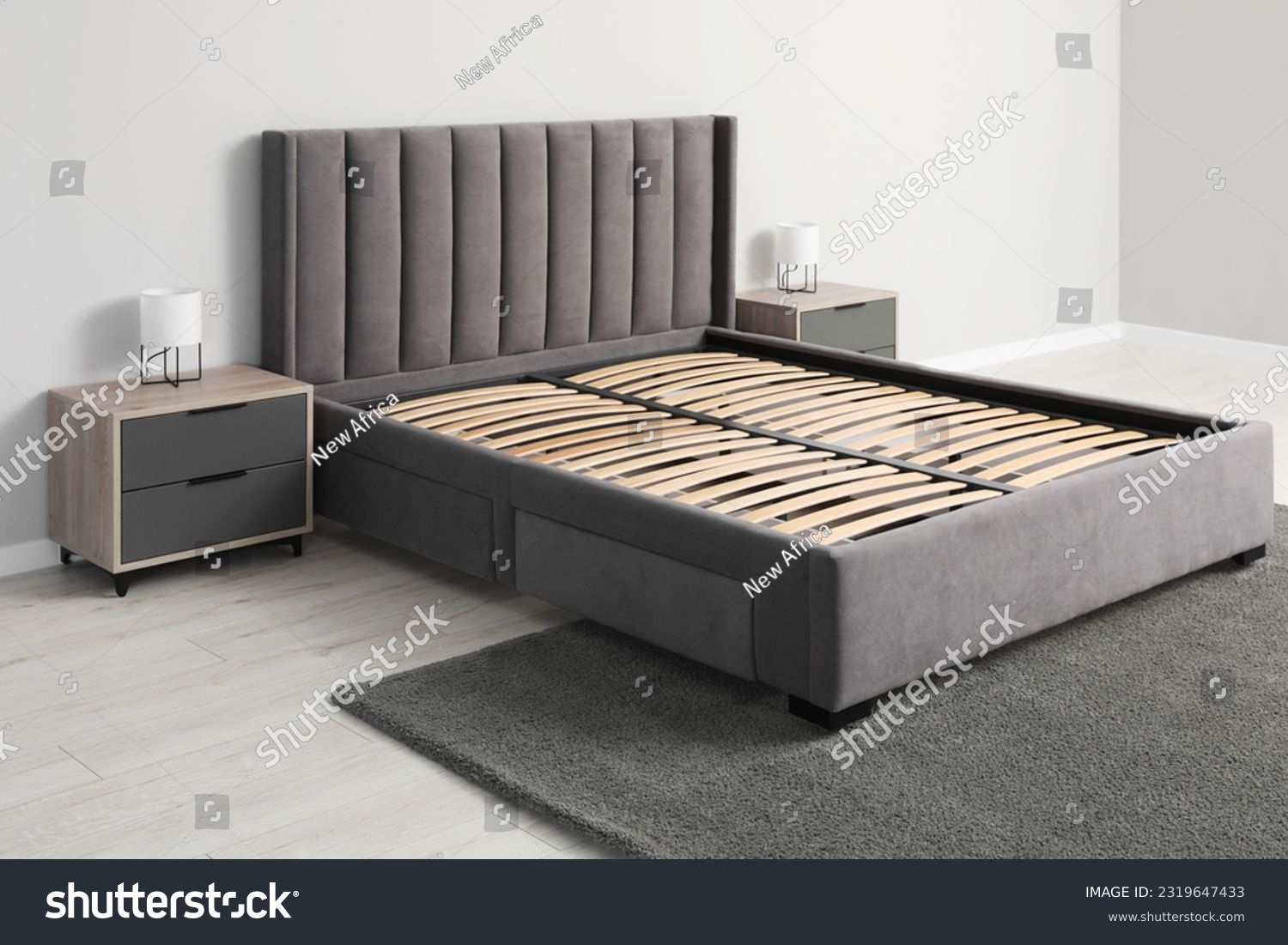 Comfortable bed with storage space for bedding under slatted base in room #2319647433