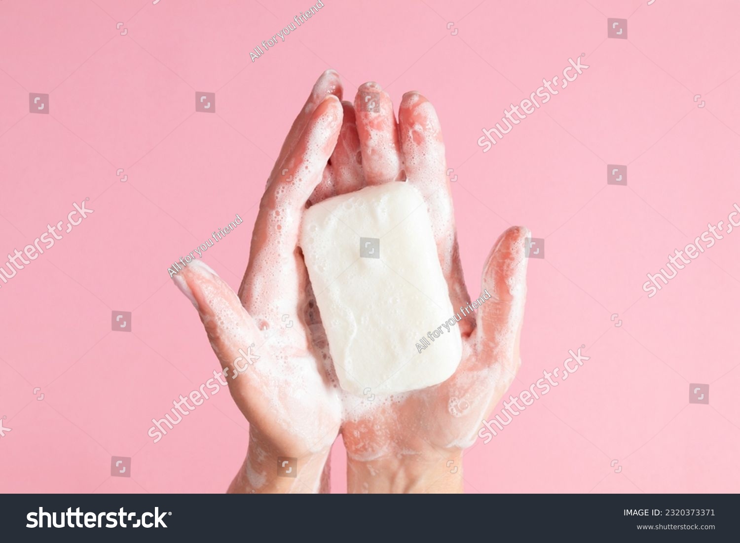 Washing of hands with soap. Cleaning hands. Closeup on woman hands with soap bar on pastel pink background. #2320373371