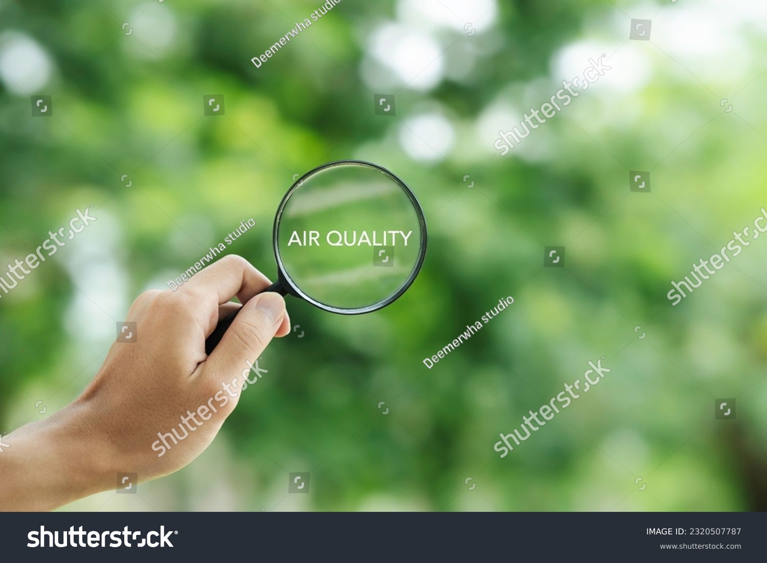 hand holding a magnifying glass to check the  good air quality and clean outdoor air quality safe from pollution dust PM 2.5 #2320507787