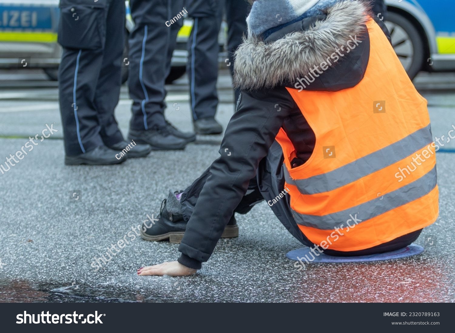 a climate activist stuck herself to the asphalt in hamburg #2320789163