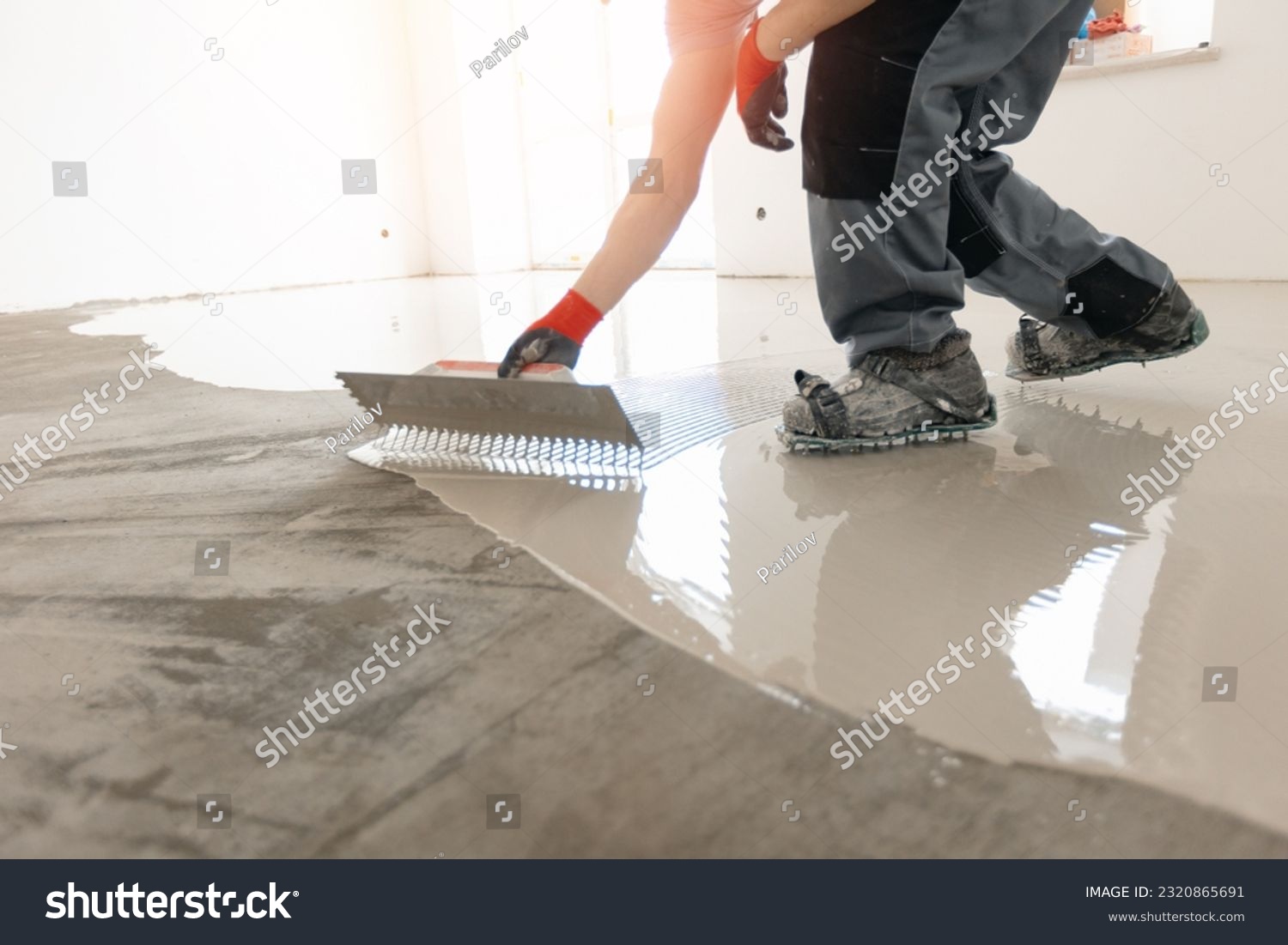 Screed concrete with self leveling cement mortar for floors. Master work renovation home. #2320865691