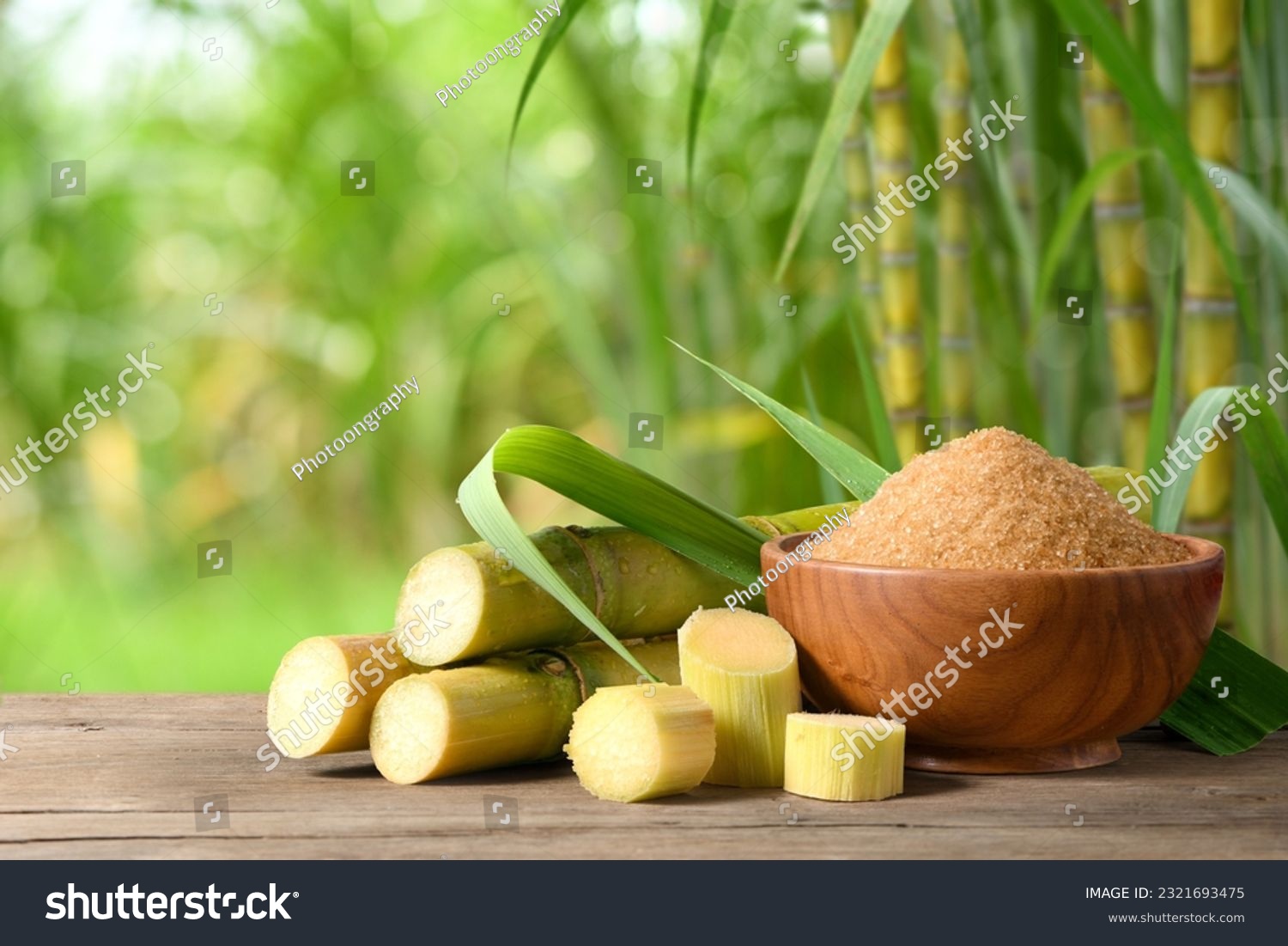 Brown sugar with fresh sugar cane on wooden table with sugar cane plantation farming background. #2321693475