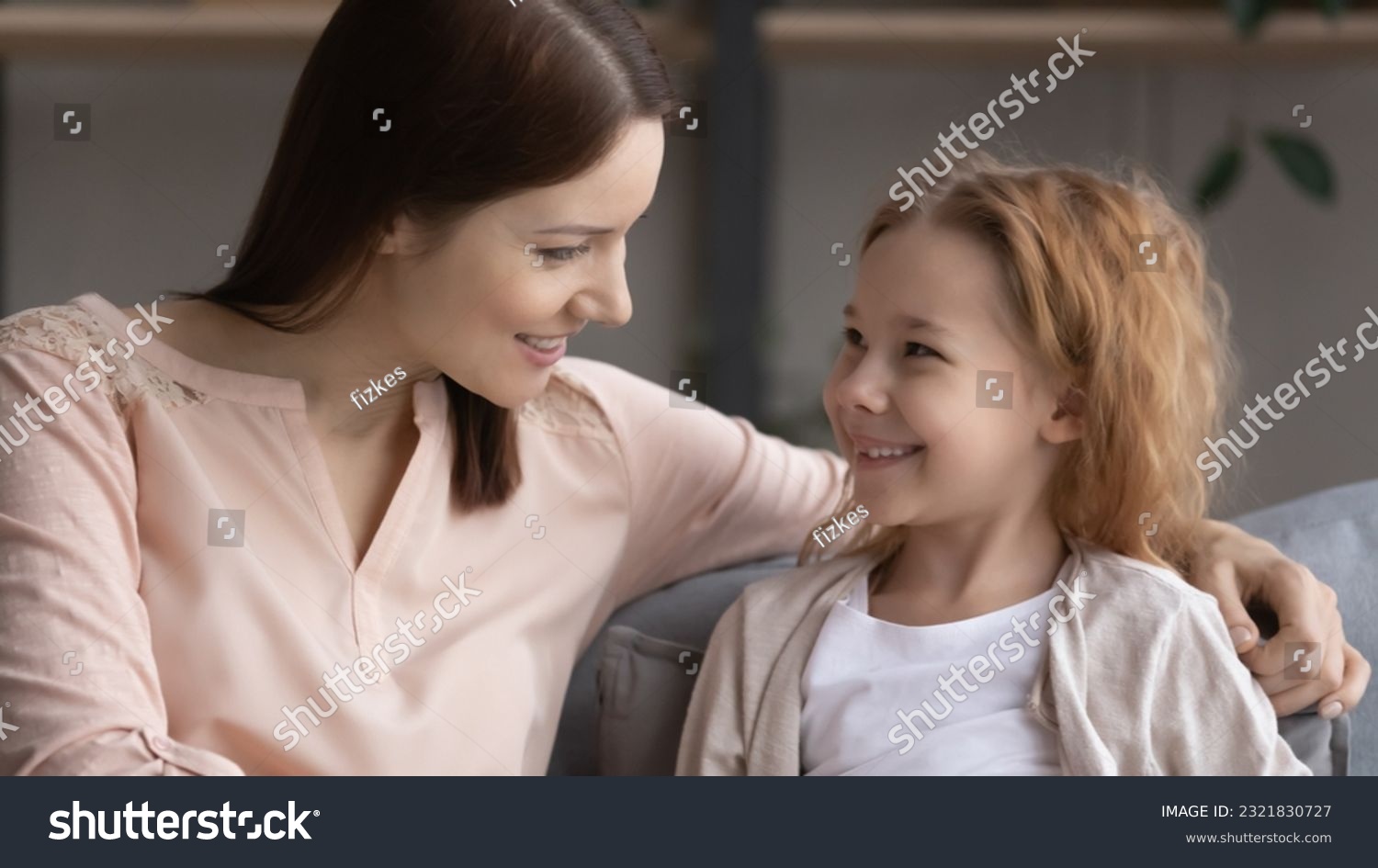 Pleasant conversation. Happy preteen girl sit on couch glad to talk to friendly female teacher psychologist answer questions discuss school life. Smiling little daughter ask supportive mom for advice #2321830727