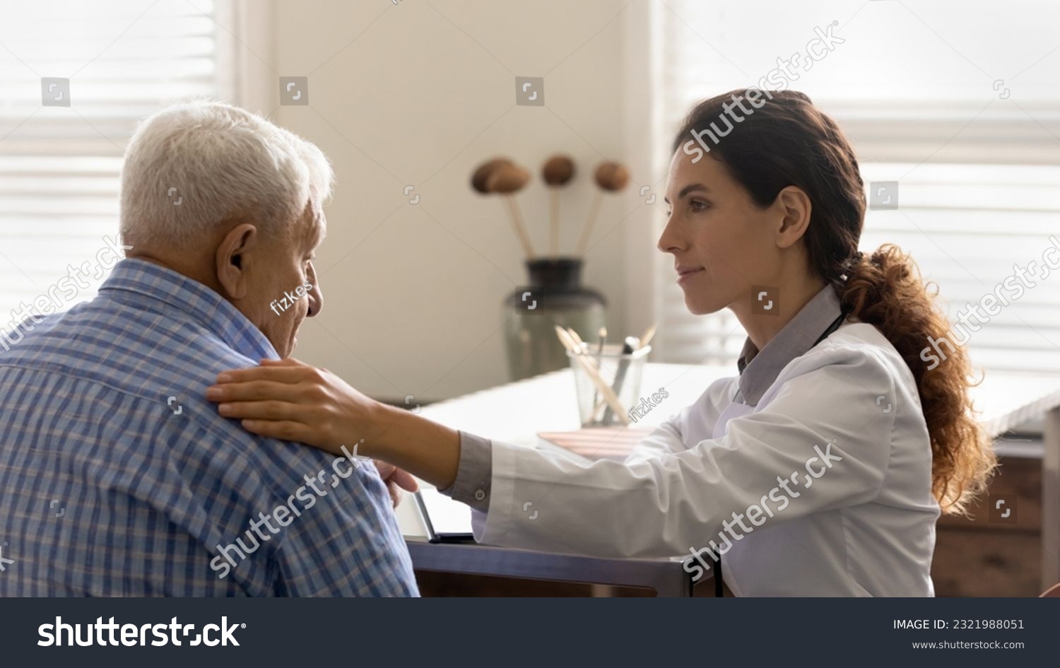 Caring female nurse touch support elderly male patient hear bad news results at hospital consultation. Woman doctor comfort caress old man client at meeting. Geriatrics medicine, healthcare concept. #2321988051