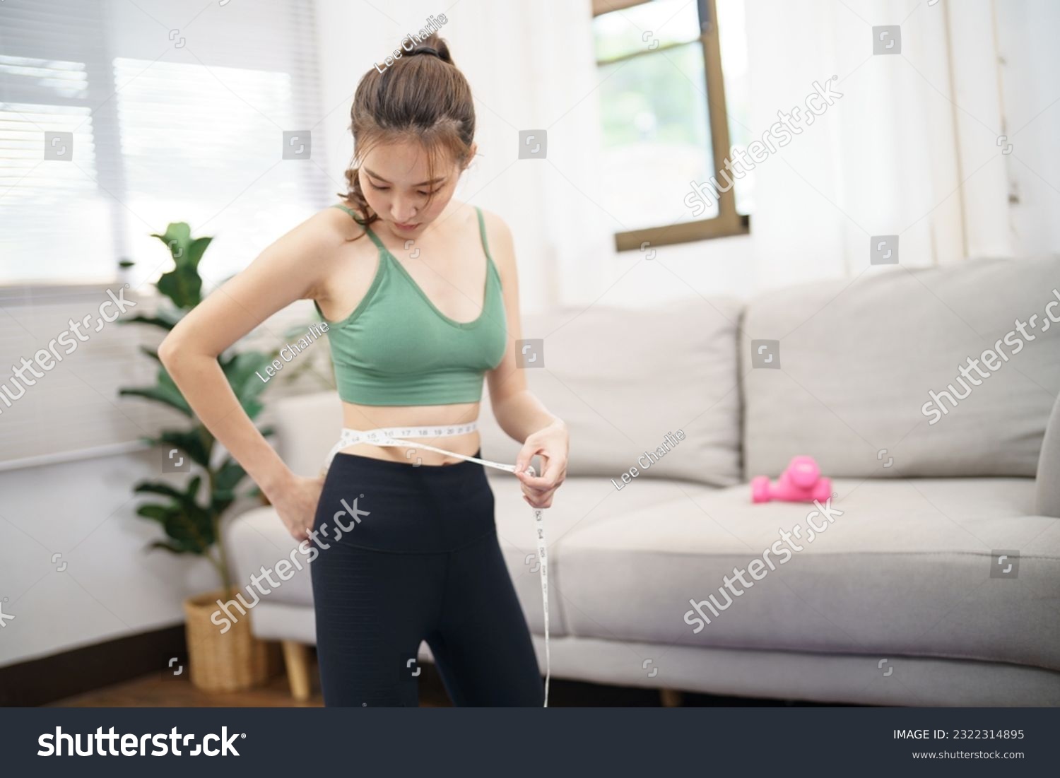 Asian woman with anorexia  with measuring tape feeling unhappy. Anorexia problem body perception and dysmorphia conceptใ #2322314895