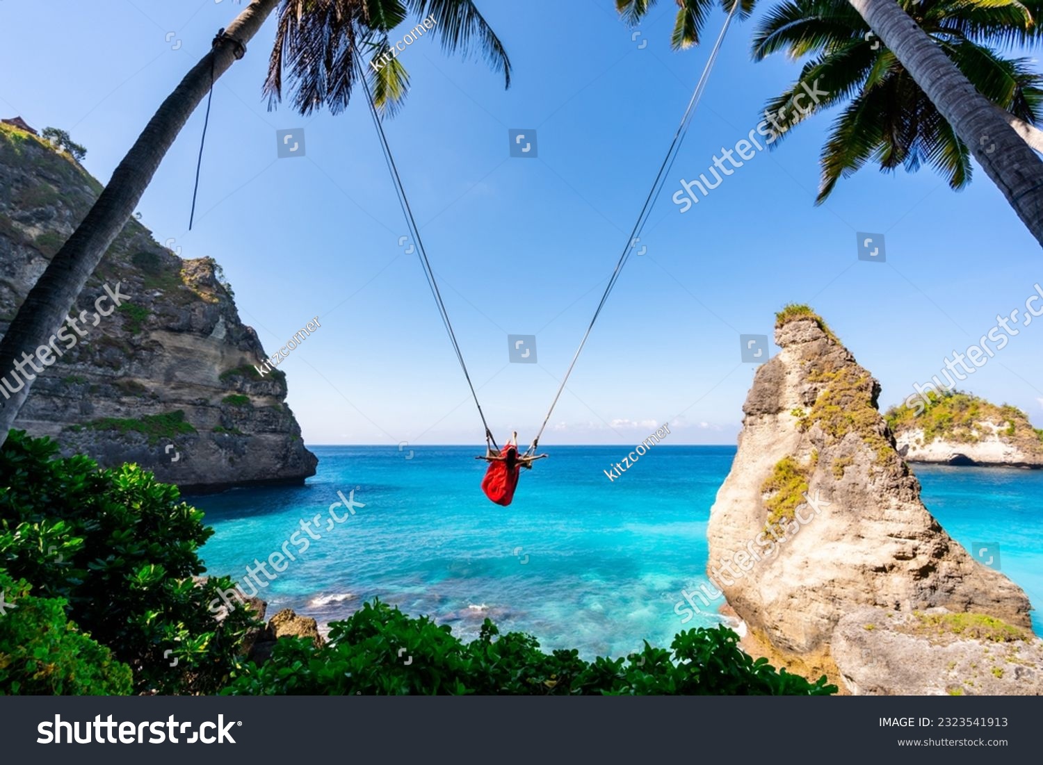 Young woman tourist on Bali swing at Diamond beach at Nusa Penida island Bali ,Indonesia #2323541913