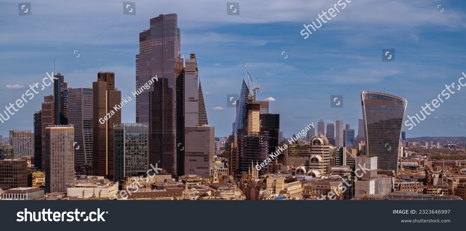 Panoramic aerial city scape about London city with skyscapers. Amazing sunny day with a bit cloudy sky. 
 #2323646997