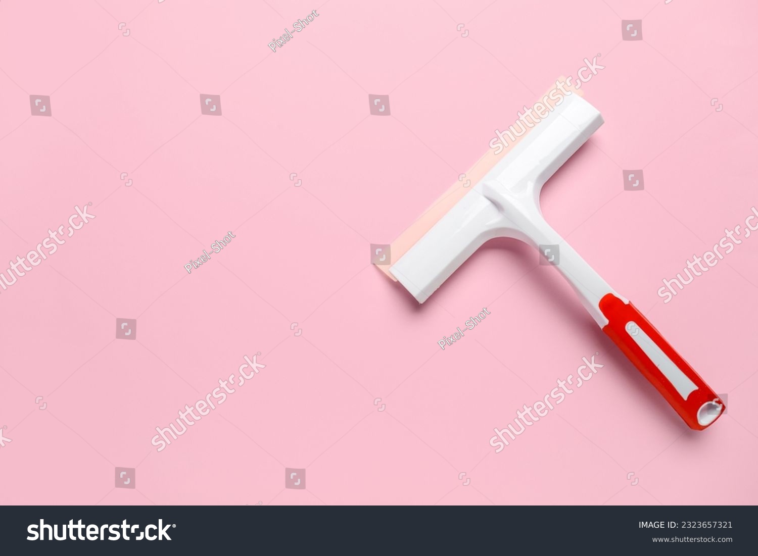 White plastic squeegee on pink background #2323657321