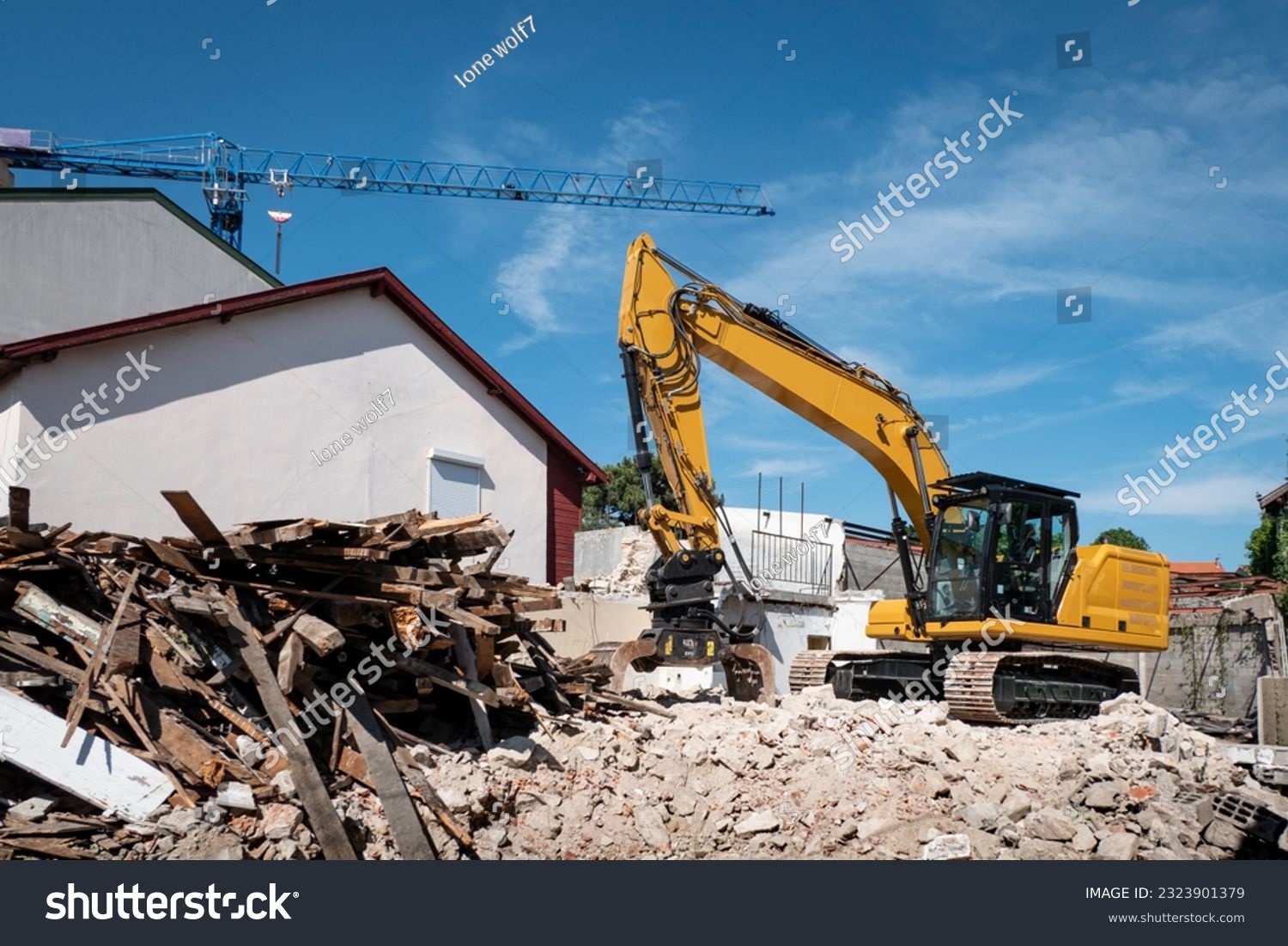 Excavator demolishing an old house for later construction on the site #2323901379