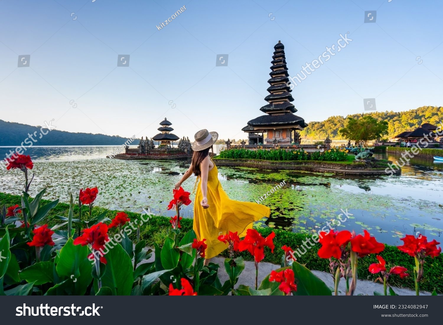 Young woman tourist relaxing and enjoying the beautiful view at Ulun Danu Beratan temple in Bali, Indonesia #2324082947