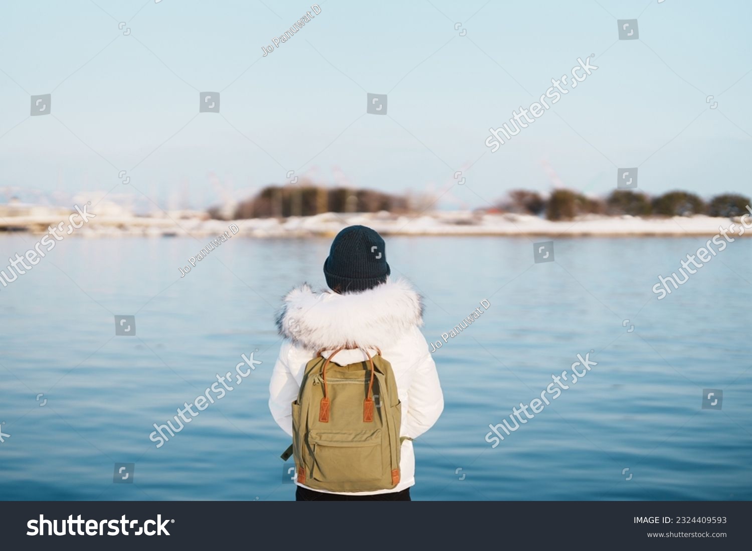 Woman tourist Visiting in Hakodate, Traveler in Sweater sightseeing Hakodate port near Red Brick Warehouse with Snow in winter. Hokkaido, Japan.Travel and Vacation concept #2324409593