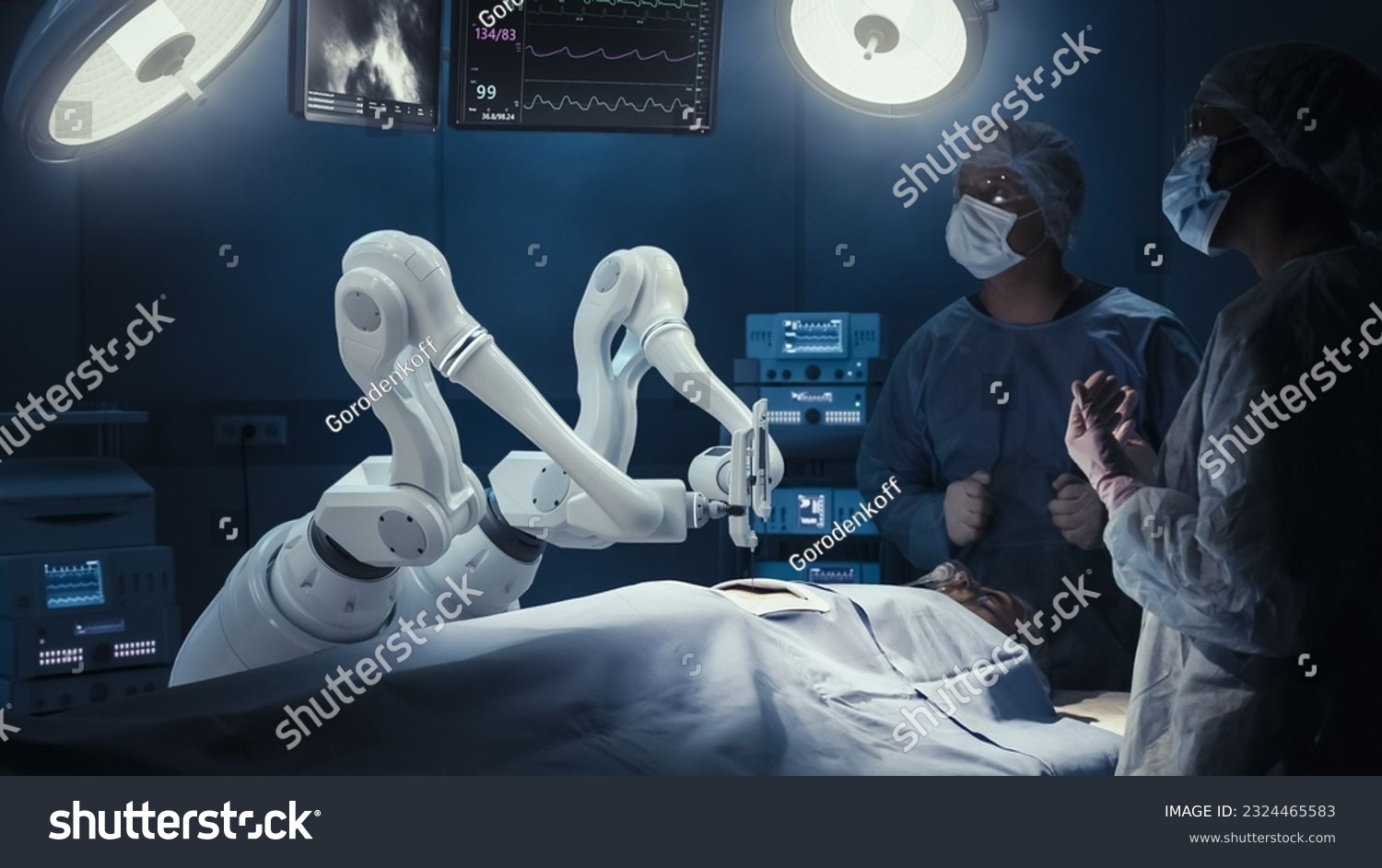 Two Surgeons Observing High-Precision Programmable Automated Robot Arms Operating Patient In High-Tech Hospital. Robotic Limbs Performing Complicated Nanosurgery, Doctors Looking At Vitals On Monitor. #2324465583