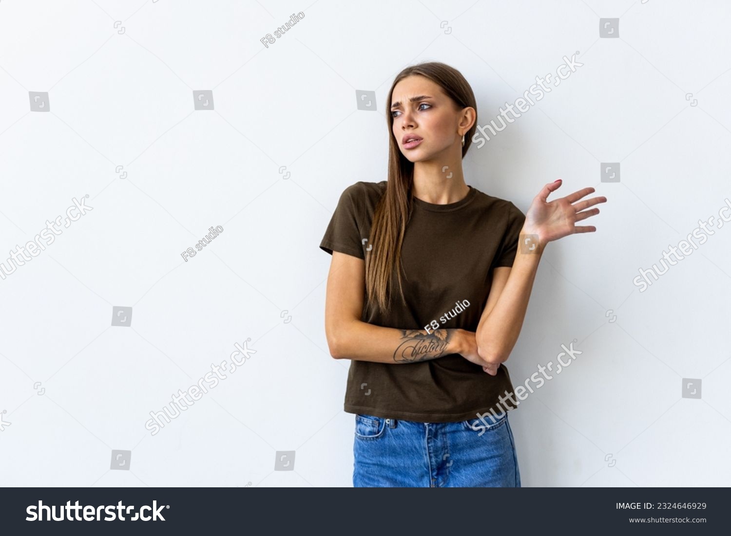 Whats your problem. Arrogant snobbish young brunette in red t-shirt shrugging raise hands look with disdain and confusion, feeling questioned and bothered with strange accusation, white background #2324646929