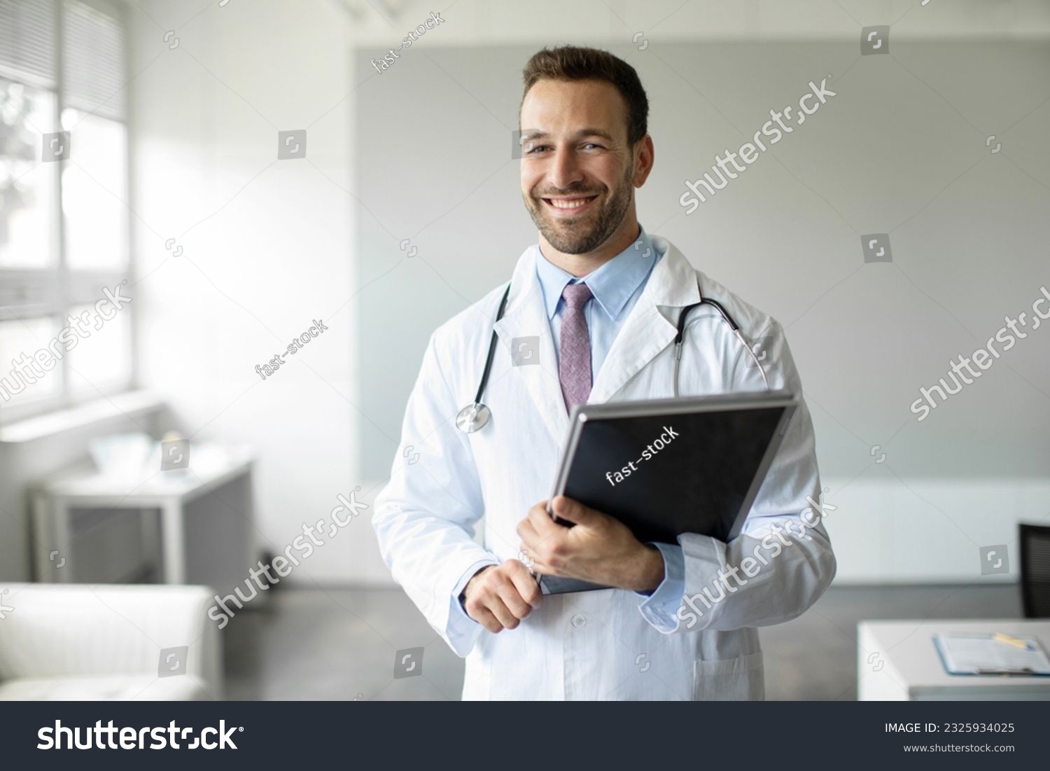 Portrait of cheerful man doctor holding clipboard smiling at camera, male physician gp working in clinic, wearing white medical uniform, copy space #2325934025