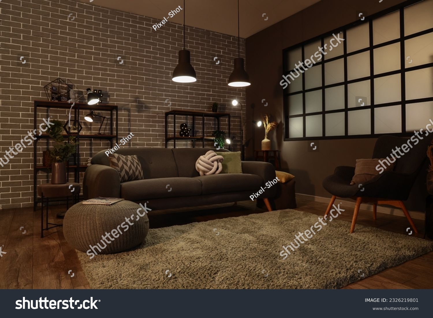 Interior of dark living room with cozy grey sofa and glowing lamps #2326219801
