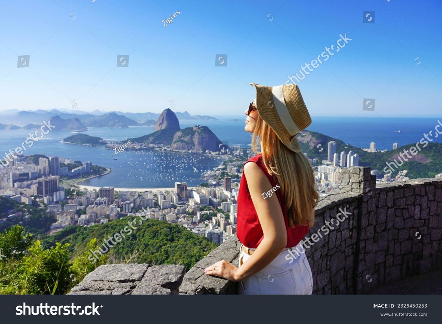 Fashion tourist woman on terrace in Rio de Janeiro with the famous Guanabara bay and the cityscape of Rio de Janerio, Brazil #2326450253