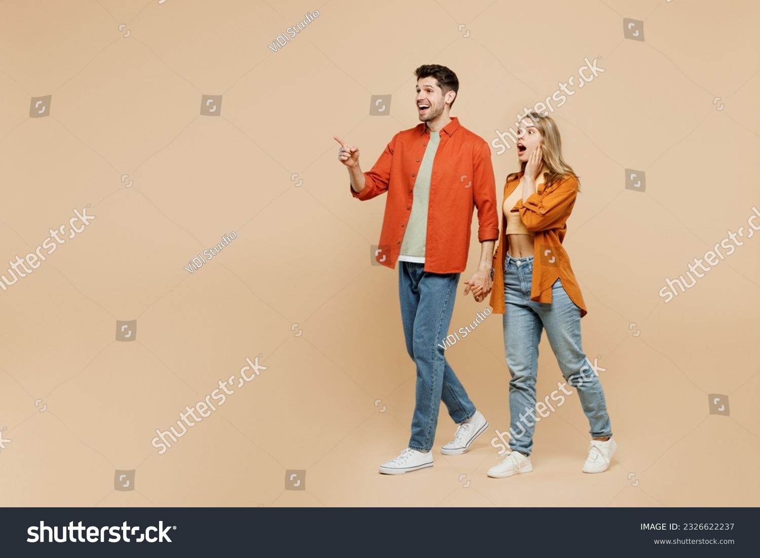 Full body young couple two friends family man woman wear casual clothes together point index finger aside indicate on workspace area copy space mock up isolated on pastel plain beige color background #2326622237