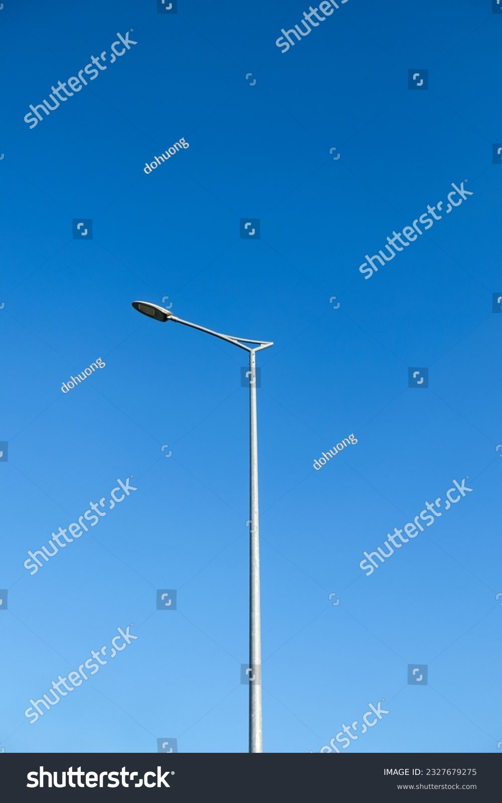 Street lamp post against a very clear blue sky on daylight. #2327679275