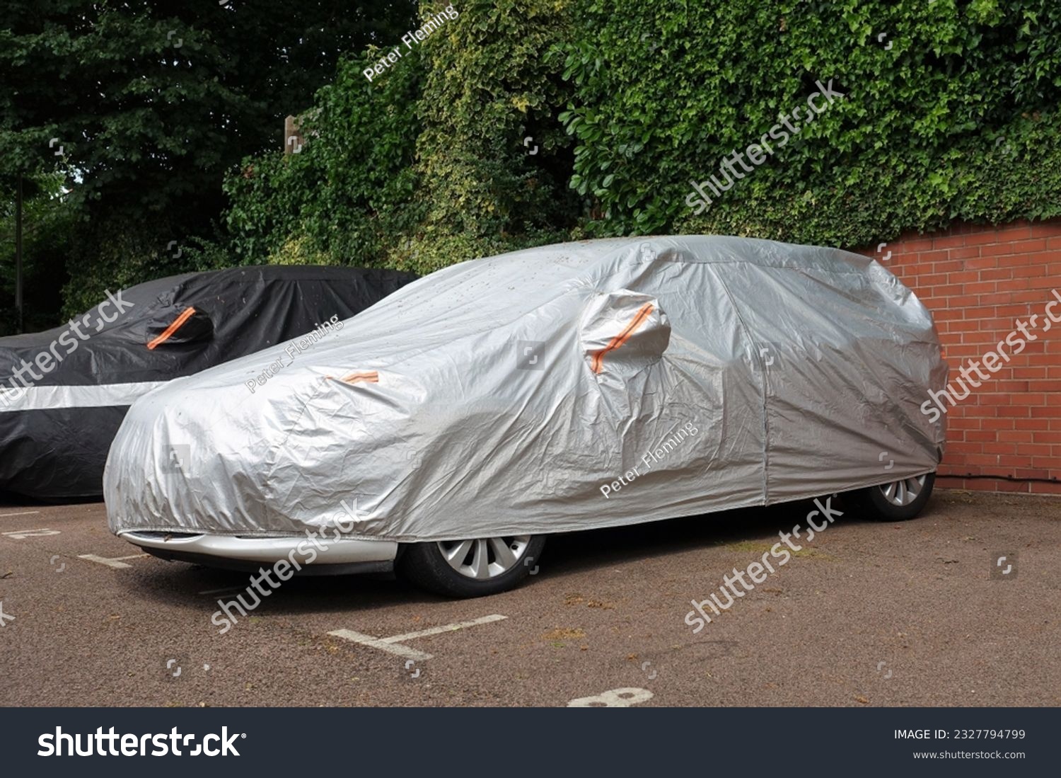 Vehicle under protective cover in parking space #2327794799