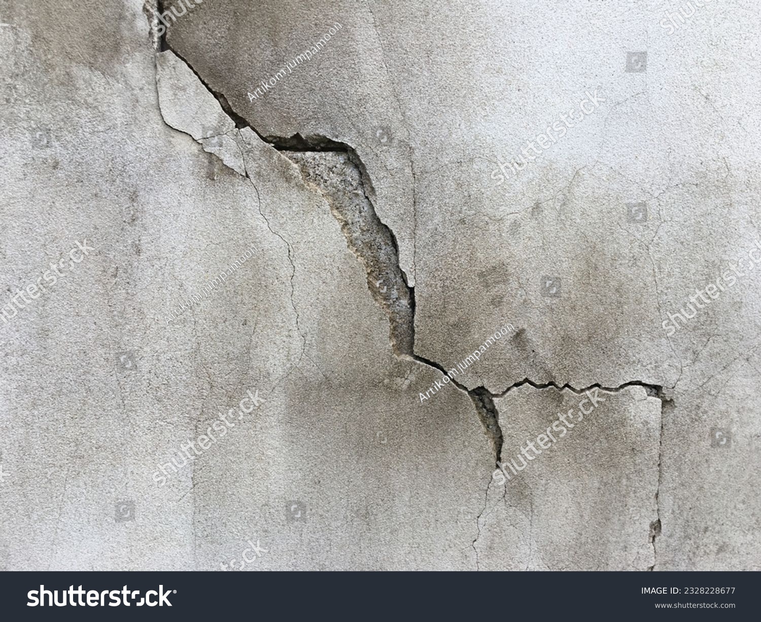 Close-up of cracked concrete wall. Cracked concrete should be fixed. #2328228677