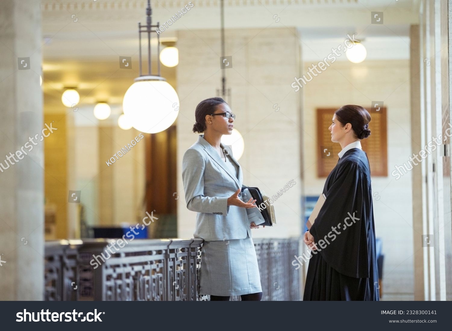Judge and lawyer talking in courthouse #2328300141