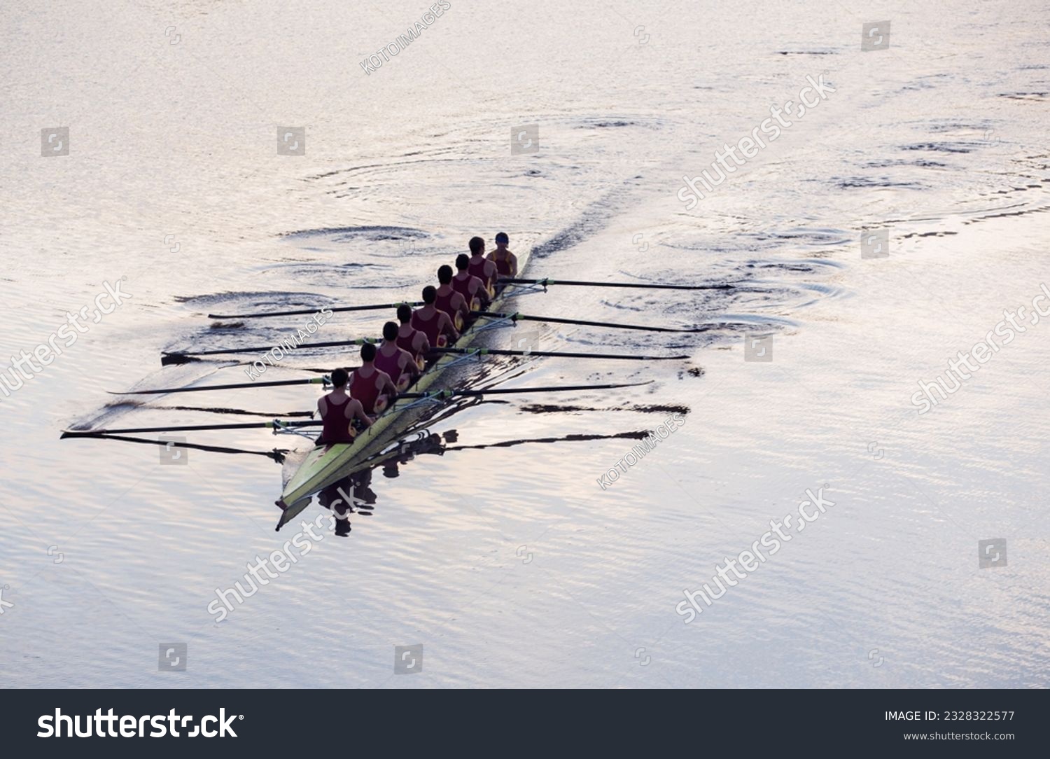 Rowing team rowing scull on lake #2328322577