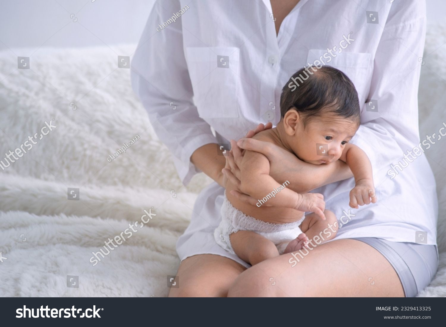 Portrait of newborn baby boy sitting on mother lap, caring love tenderness concept #2329413325