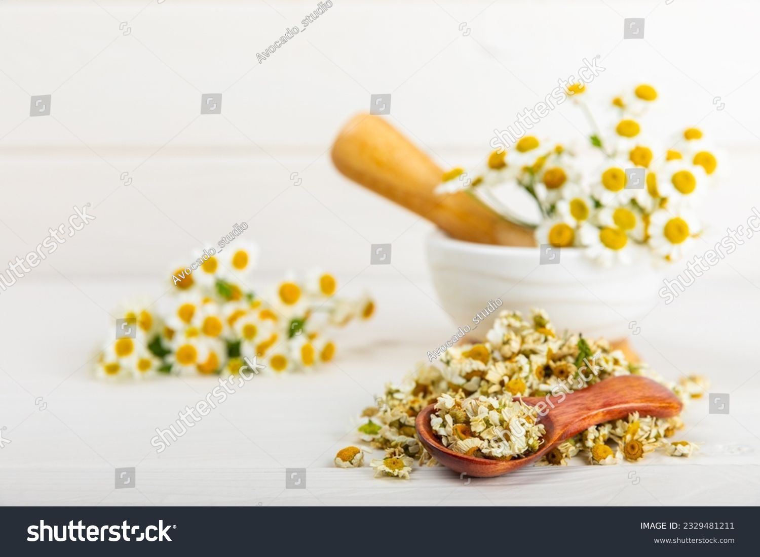 Dried chamomile tea on texture table.dry chamomile. Chamomile tea. flat lay. Composition with a bouquet and chamomile inflorescences in a mortar. Herbal drink. Soothing and tonic tea. copy space. #2329481211