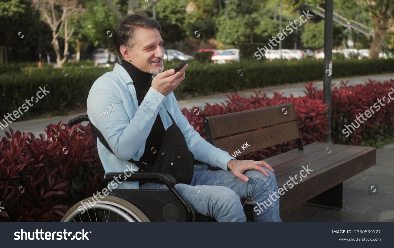 Positive disabled man Middle eastern man dictation voice message and sending using mobile phone. Disability and lifestyle concept. #2330539127