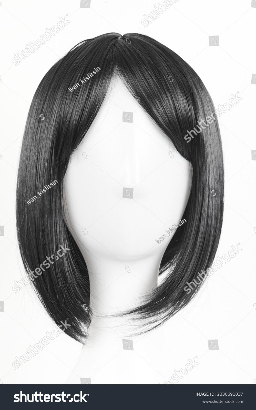 Natural looking black wig on white mannequin head. Medium length straight hair with bangs on the metal wig holder isolated on white background, front view #2330691037