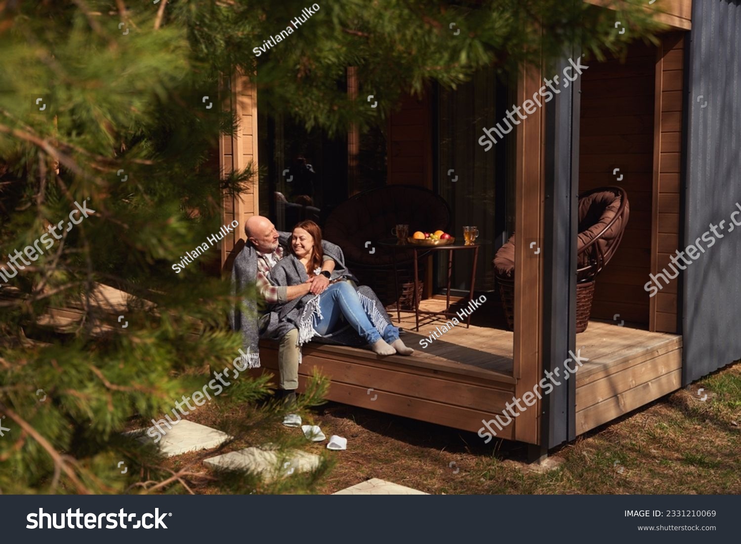Couple in love resting on cottage veranda #2331210069