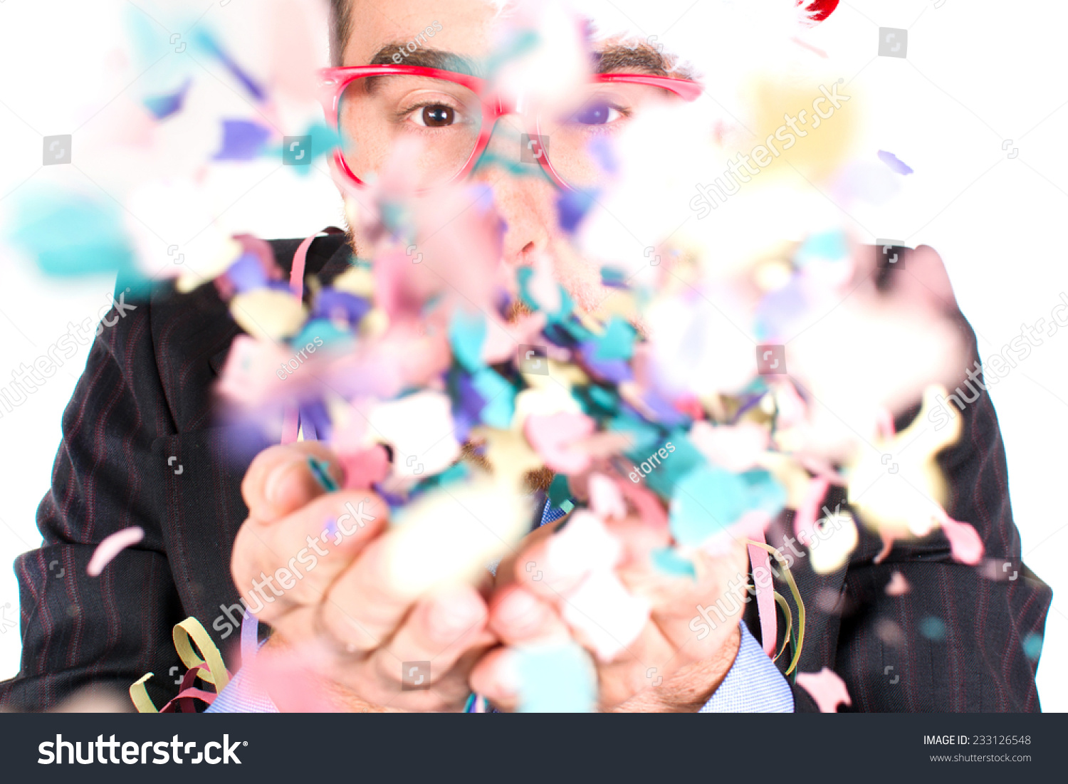 Young man blowing confetti #233126548