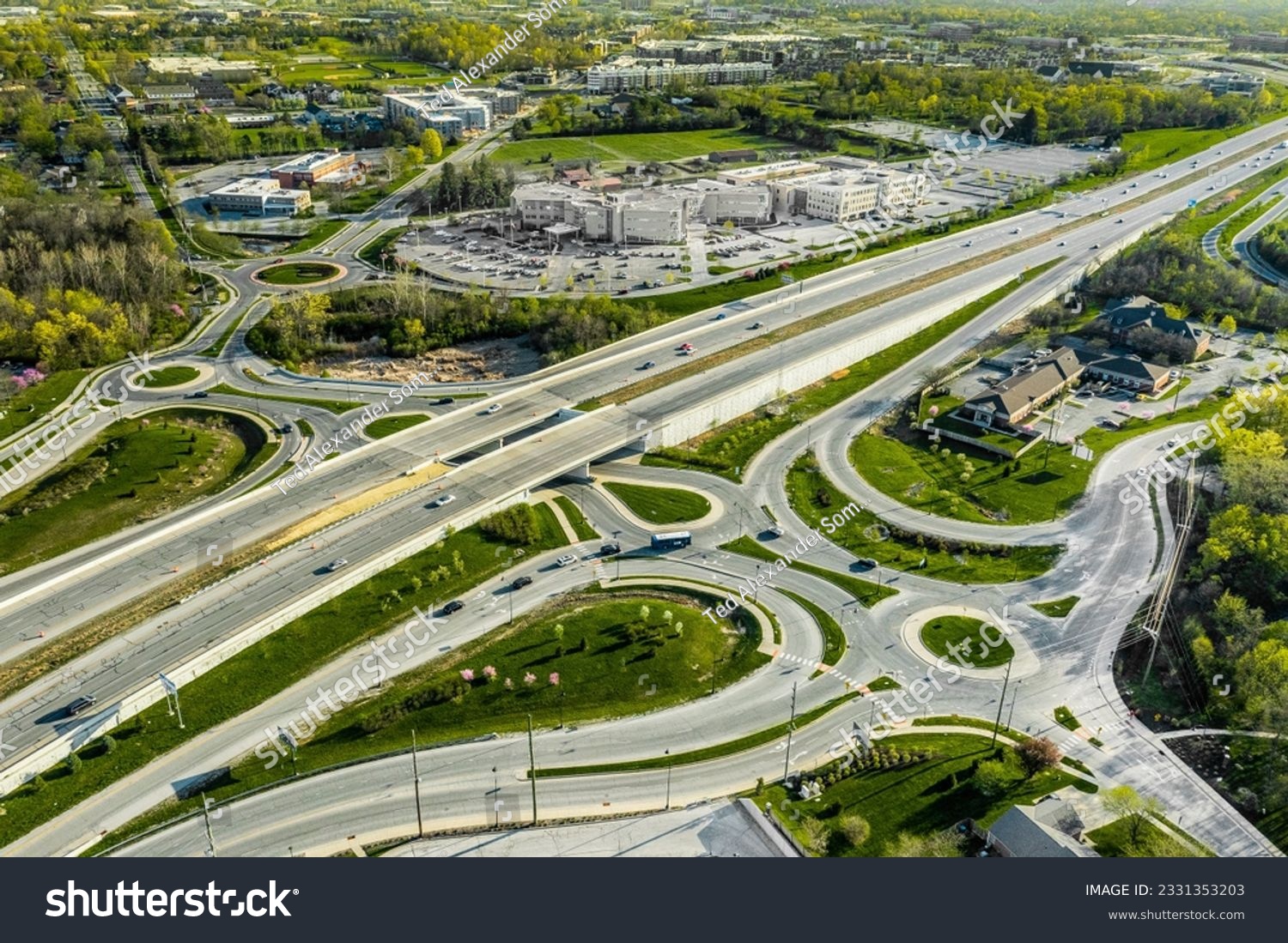 A drone view of a group of roundabouts and a highway #2331353203