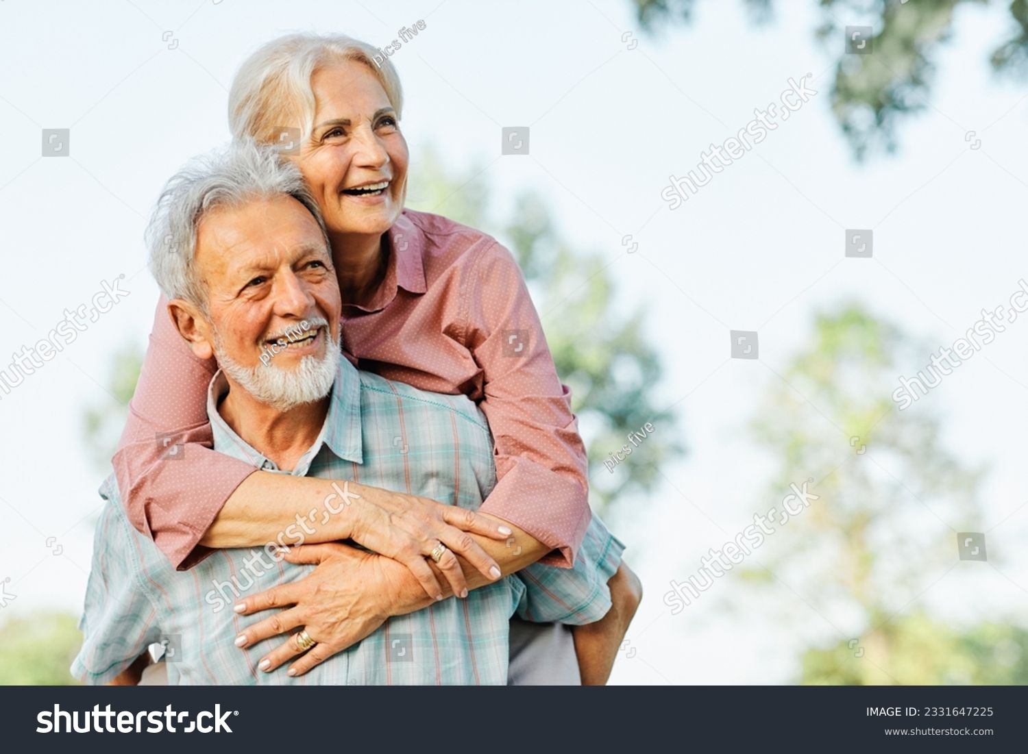 Happy active senior couple having fun outdoors. Portrait of an elderly couple together #2331647225