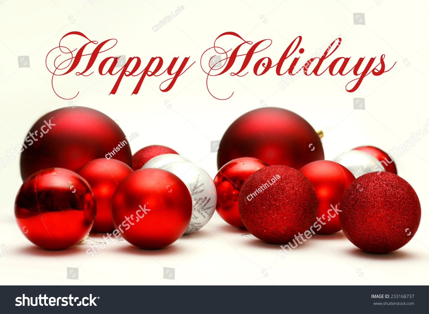A Collection White and Red Sparkling Christmas Bulb Ornaments are Scattered on a White Background, with the text Happy Holidays. #233168737