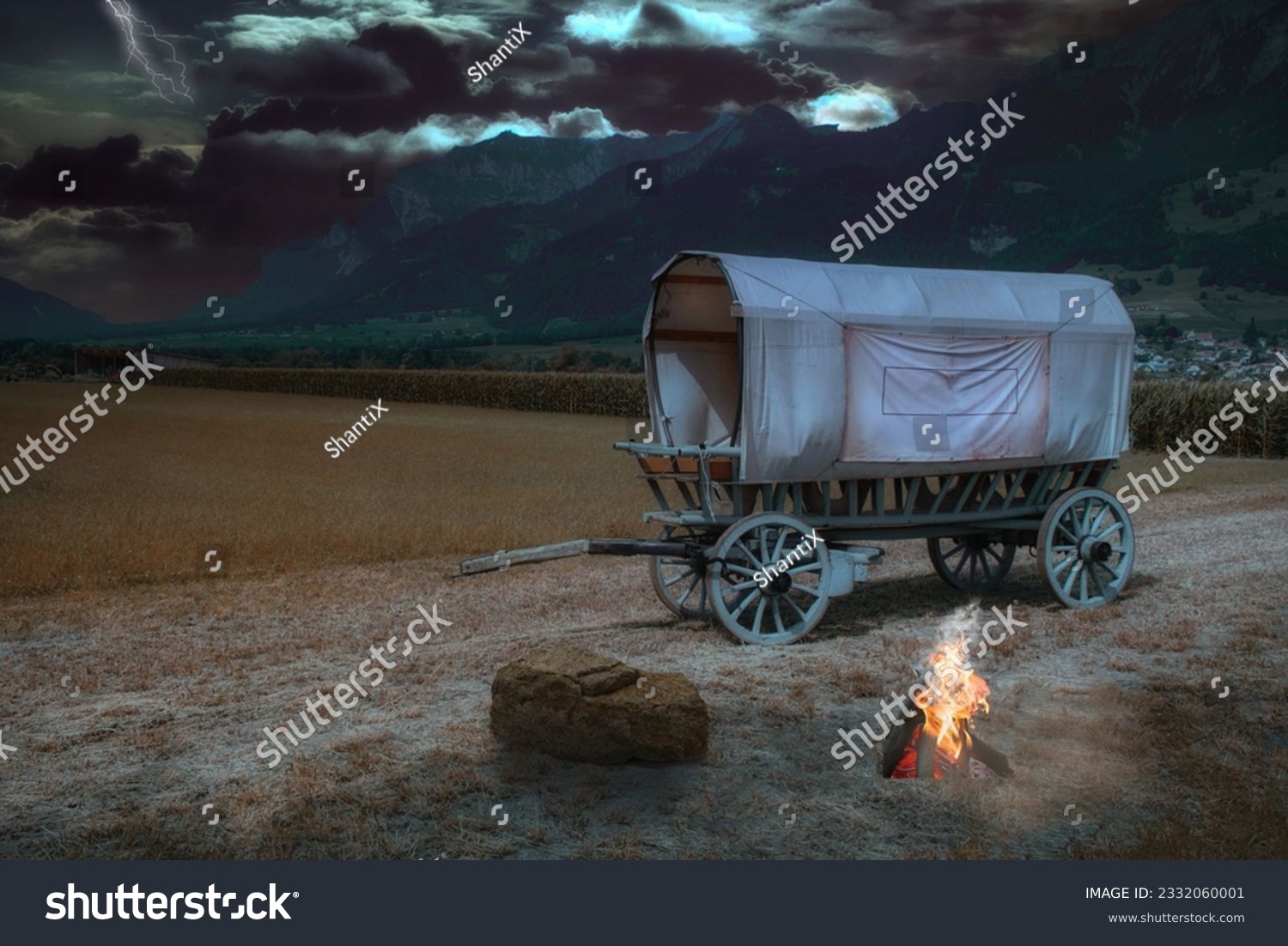 Covered wagon near Landquart in a thunderstorm atmosphere and campfire #2332060001